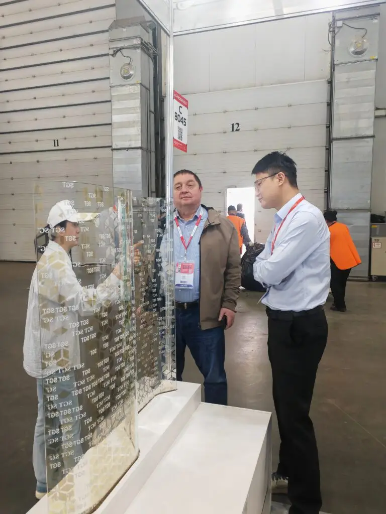 SGT sales manager introducing curved digital printed Low-E laminated glass sample at MosBuild exhibition