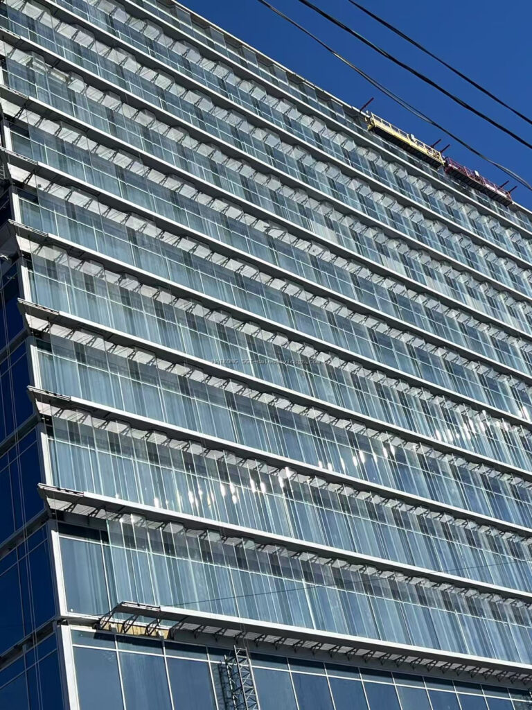 Heat-bent custom laminated glass installed on a curved cultural building facade