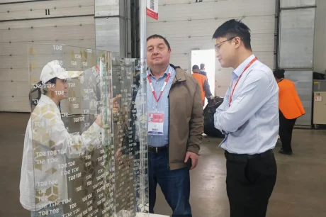 SGT sales manager introducing curved digital printed Low-E laminated glass sample at MosBuild exhibition