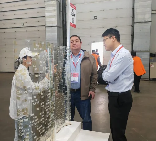 SGT sales manager introducing curved digital printed Low-E laminated glass sample at MosBuild exhibition