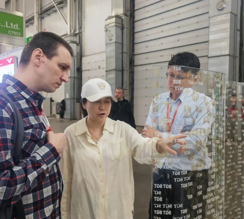 SGT sales manager introducing curved digital printed Low-E laminated glass sample at MosBuild exhibition